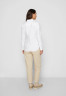 Tommy Hilfiger HERITAGE REGULAR FIT Button-down blouse classic white HERITAGE REGULAR FIT Блуза на пуговицах классический белый