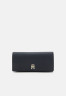 Tommy Hilfiger EMBLEM FLAP WALLET Wallet space blue КОШЕЛЕК С КЛАПАНОМ С ЭМБЛЕМОЙ Бумажник космический синий