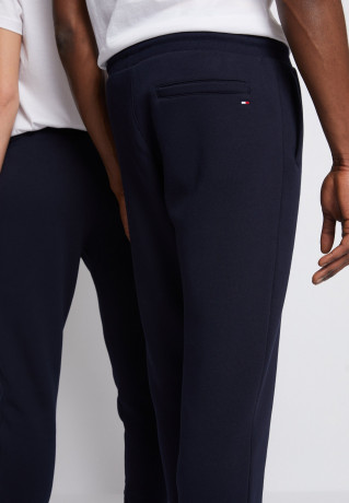 Tommy Hilfiger LOGO SWEATPANTS UNISEX Tracksuit bottoms desert sky СПОРТИВНЫЕ БРЮКИ С ЛОГОТИПОМ УНИСЕКС Спортивные штаны небо пустыни